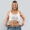 Medical Weight Loss | Smiling woman holding loose jeans around body