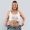 Medical Weight Loss | Smiling woman holding loose jeans around body